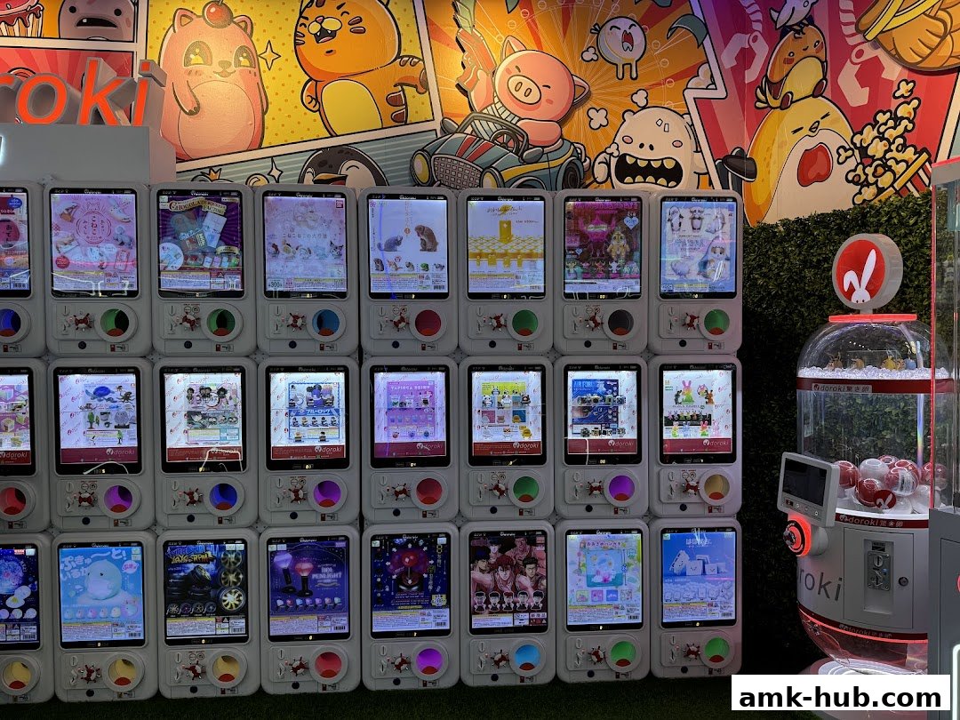 A wall of gachapon machines displaying various toys and prizes, with a large claw machine on the right.