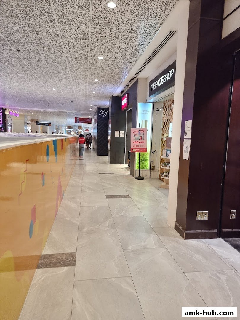 The exterior of THEFACESHOP store in a mall, with a promotional sign.