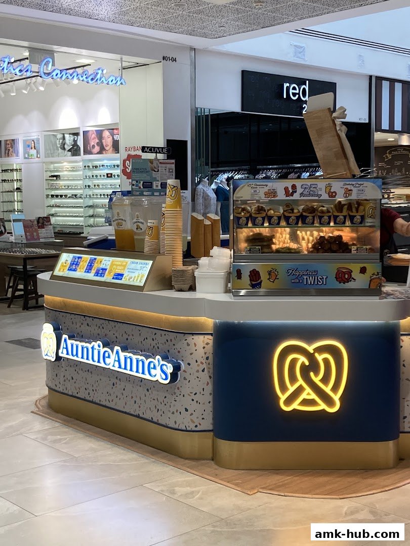 The Auntie Anne's pretzel shop counter with illuminated signage and pretzel display.