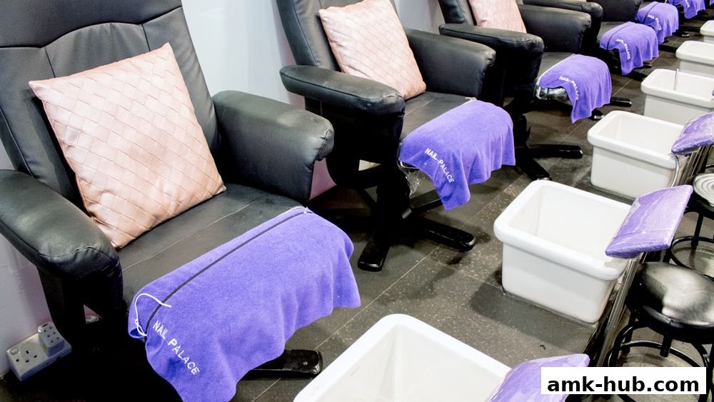 Comfortable pedicure chairs with plush cushions and purple towels at Nail Palace.