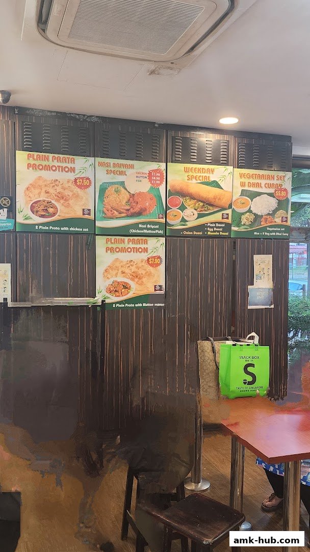 A wall display featuring various food promotions and menu items from Prata Raya.