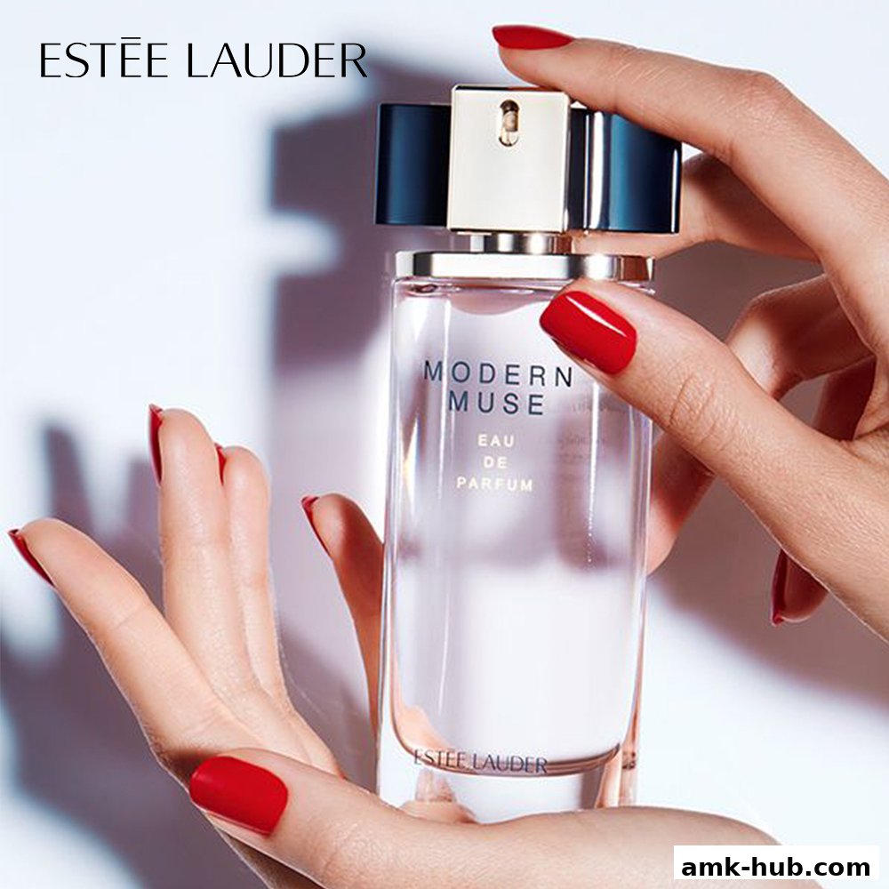 Hands holding a bottle of Estee Lauder Modern Muse Eau de Parfum.