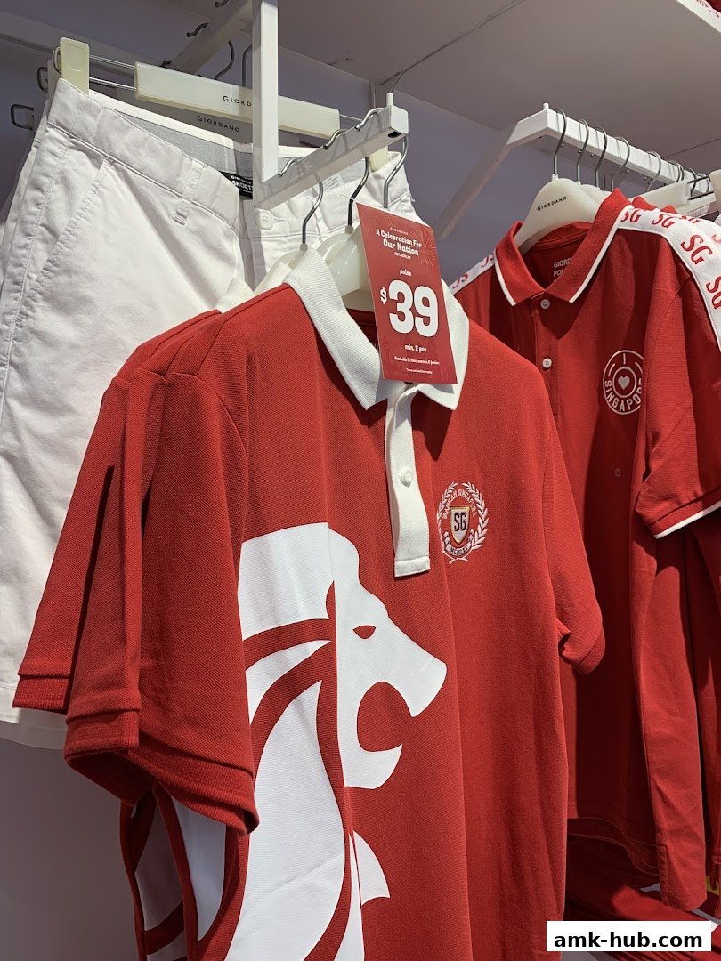 Red polo shirts with Singaporean motifs and white shorts on display at Giordano.