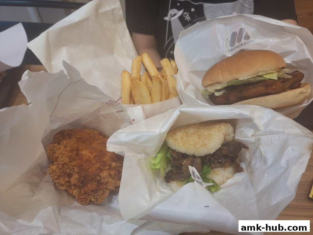 A variety of delicious MOS Burger items including burgers, fries, and fried chicken.