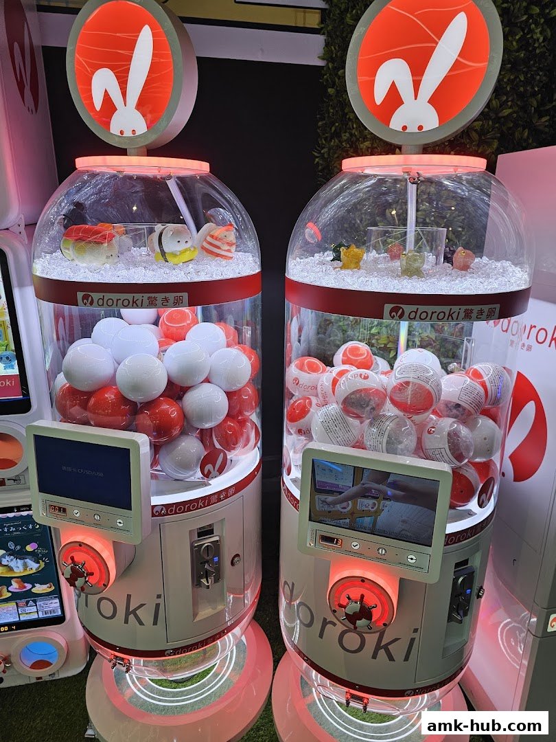 Two colorful gachapon machines filled with capsules and prizes, featuring bunny logos.
