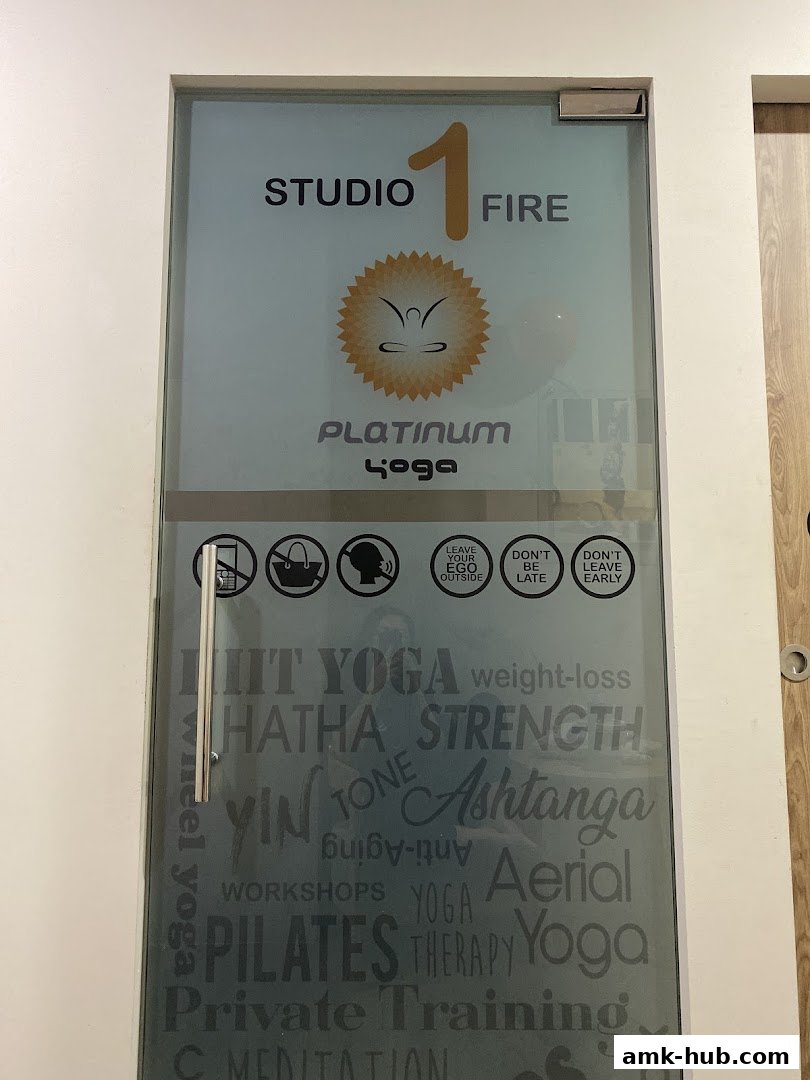 The entrance to Platinum Yoga studio, featuring the studio name and various yoga styles.