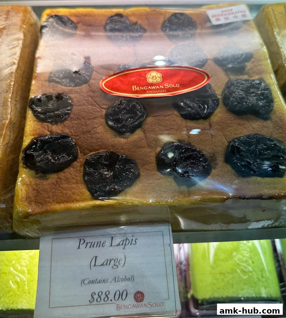 A large slice of Prune Lapis cake from Bengawan Solo, topped with prunes and priced at $88.00.