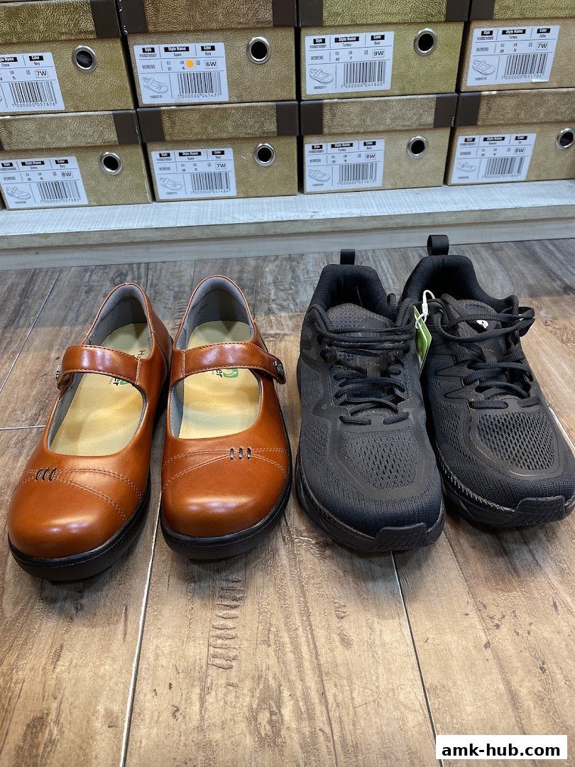 A display of comfortable women's shoes and athletic sneakers with shoe boxes in the background.