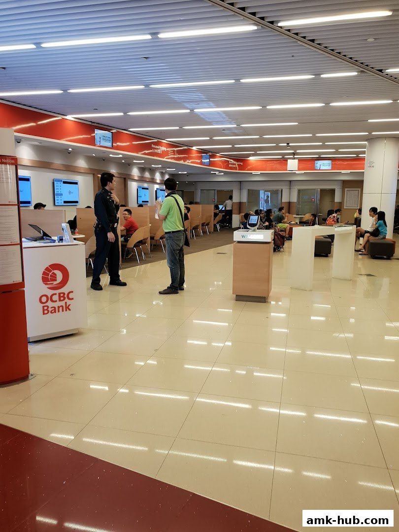Interior view of an OCBC Bank branch with customers and staff.