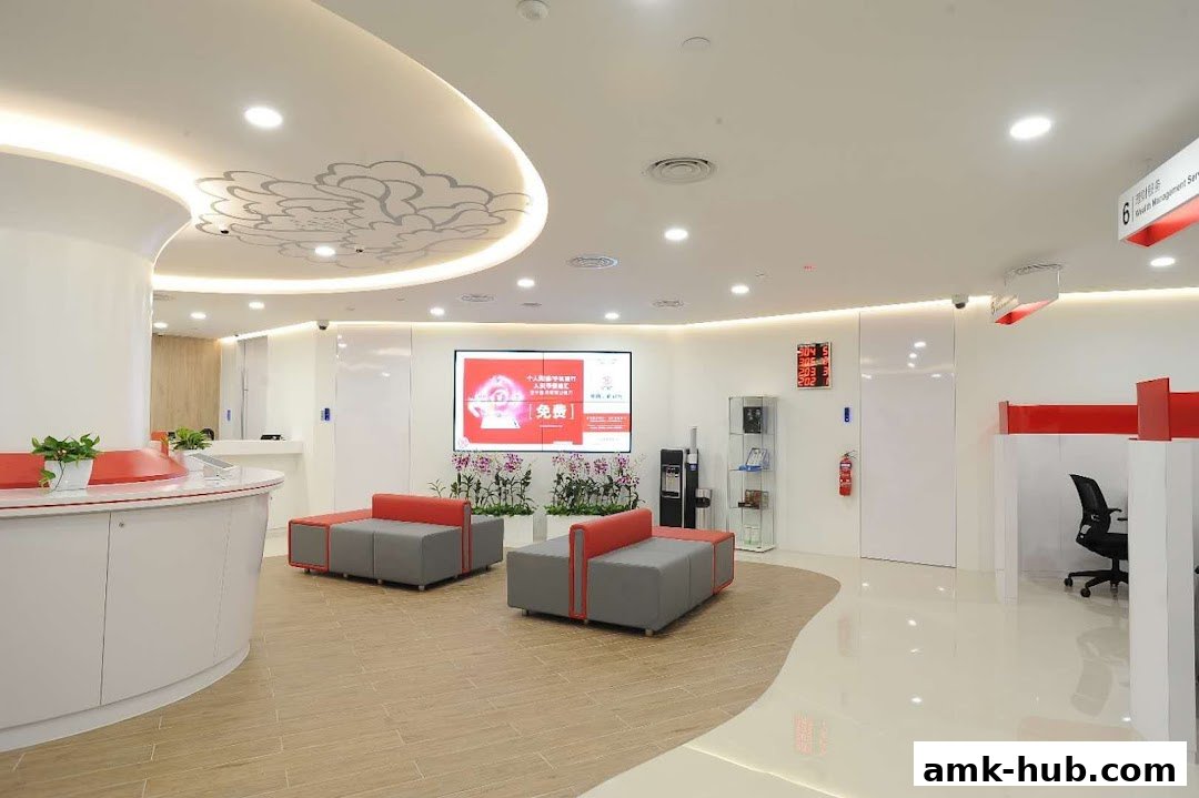 Interior of a modern bank branch with seating, digital displays, and service counters.