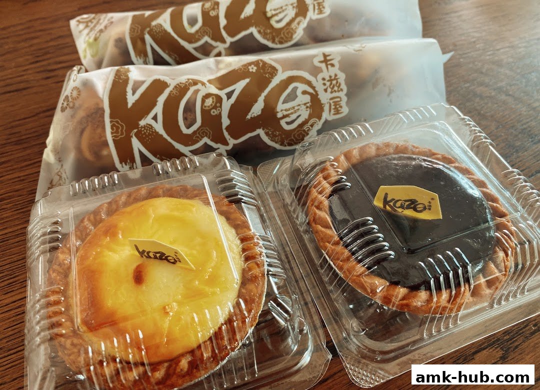 Two Kazo tarts, one with custard and one with chocolate, are packaged for takeaway.