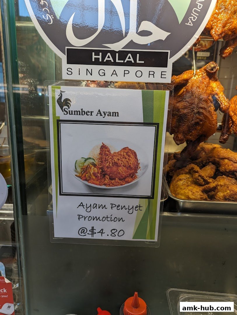 A sign advertises a Halal Ayam Penyet promotion at Sumber Ayam for $4.80.