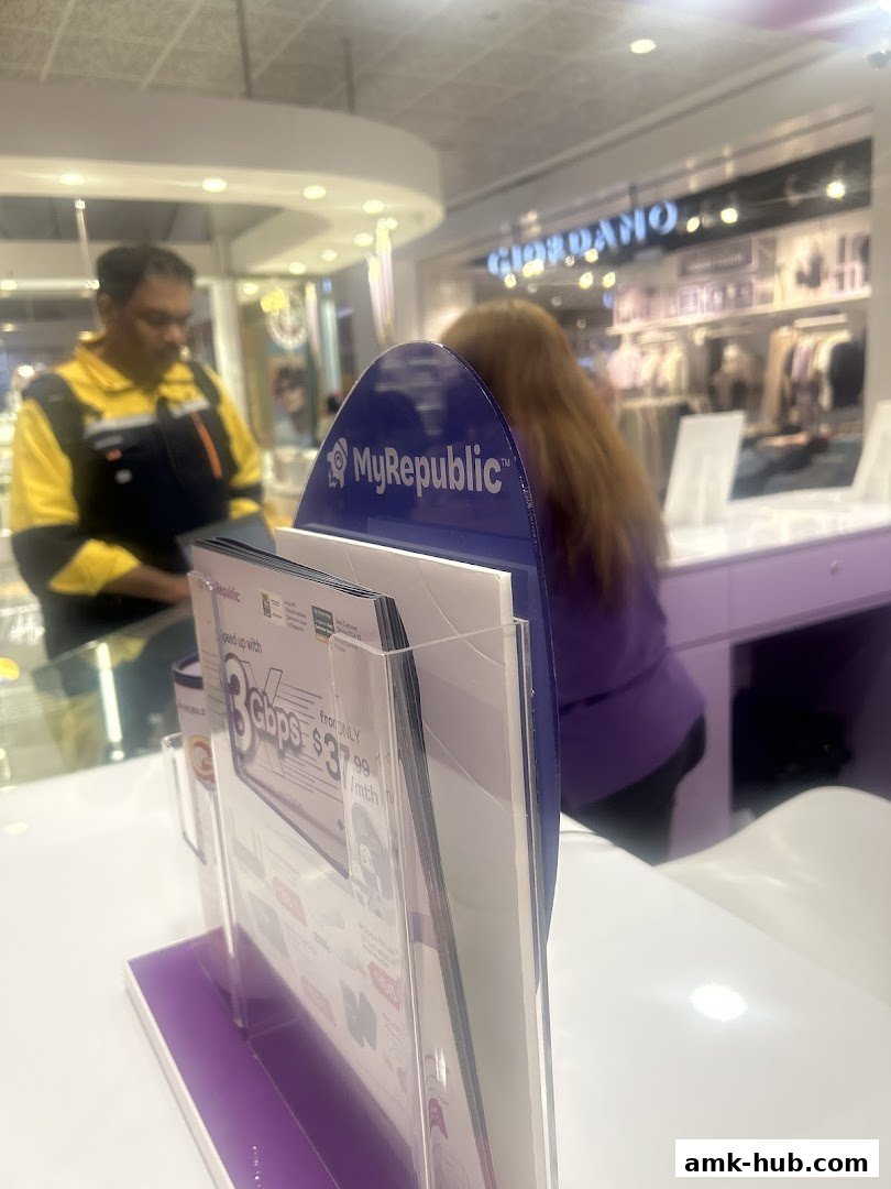 A display stand with MyRepublic branding and promotional flyers in front of a store.