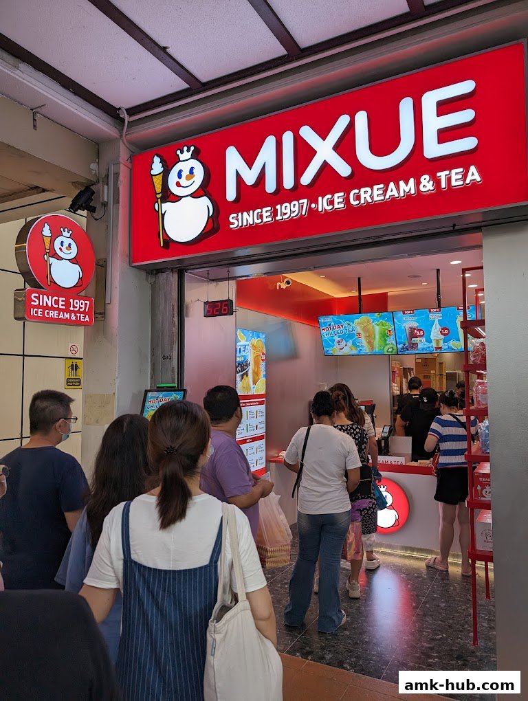 People queuing outside a MIXUE Ice Cream & Tea shop with a prominent red sign.