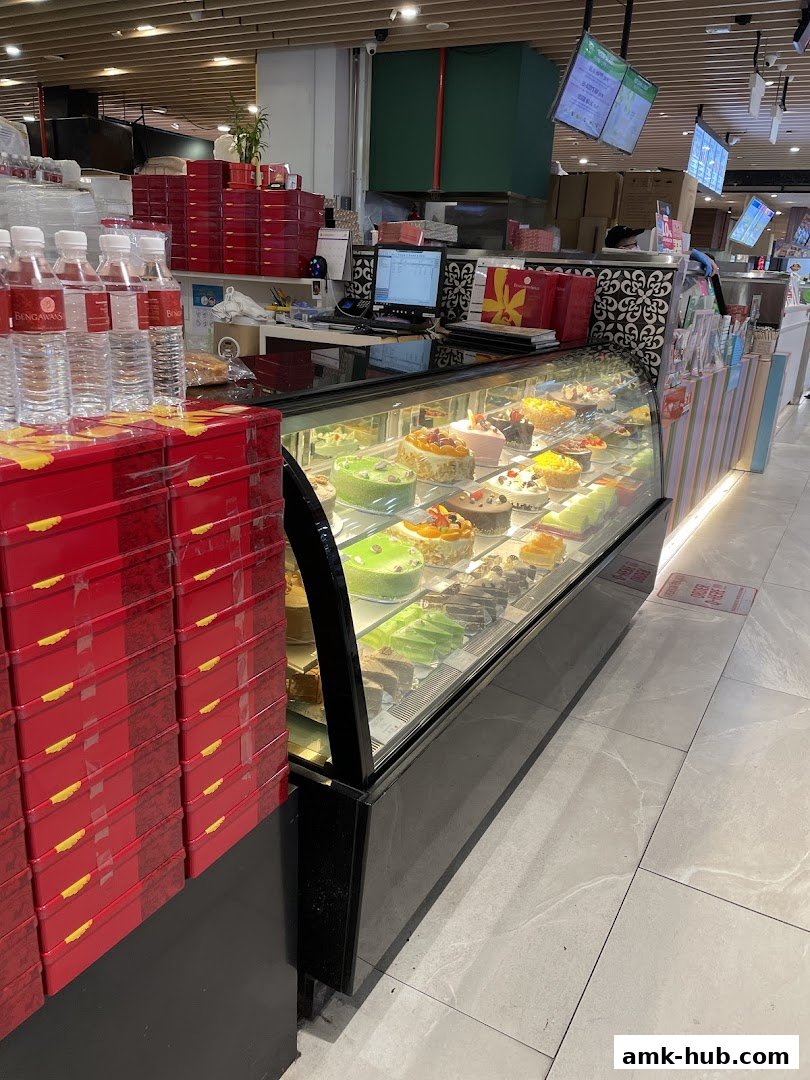 A display case filled with colorful cakes and pastries at Bengawan Solo.