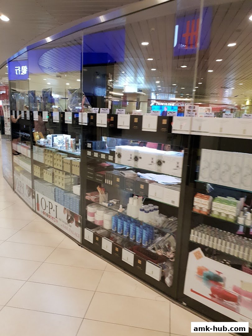 The Nail Palace shop front displays a variety of nail polish and beauty products on shelves behind glass.