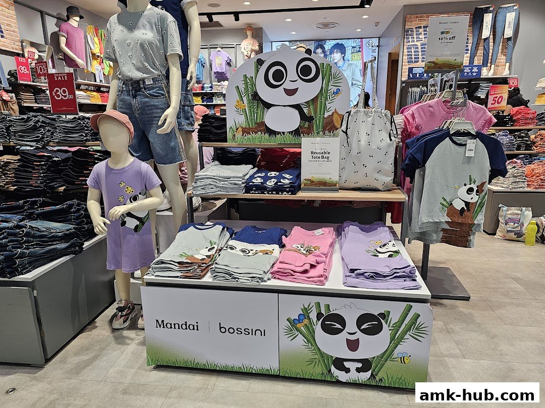A retail store display featuring children's clothing with panda designs and sale signs.