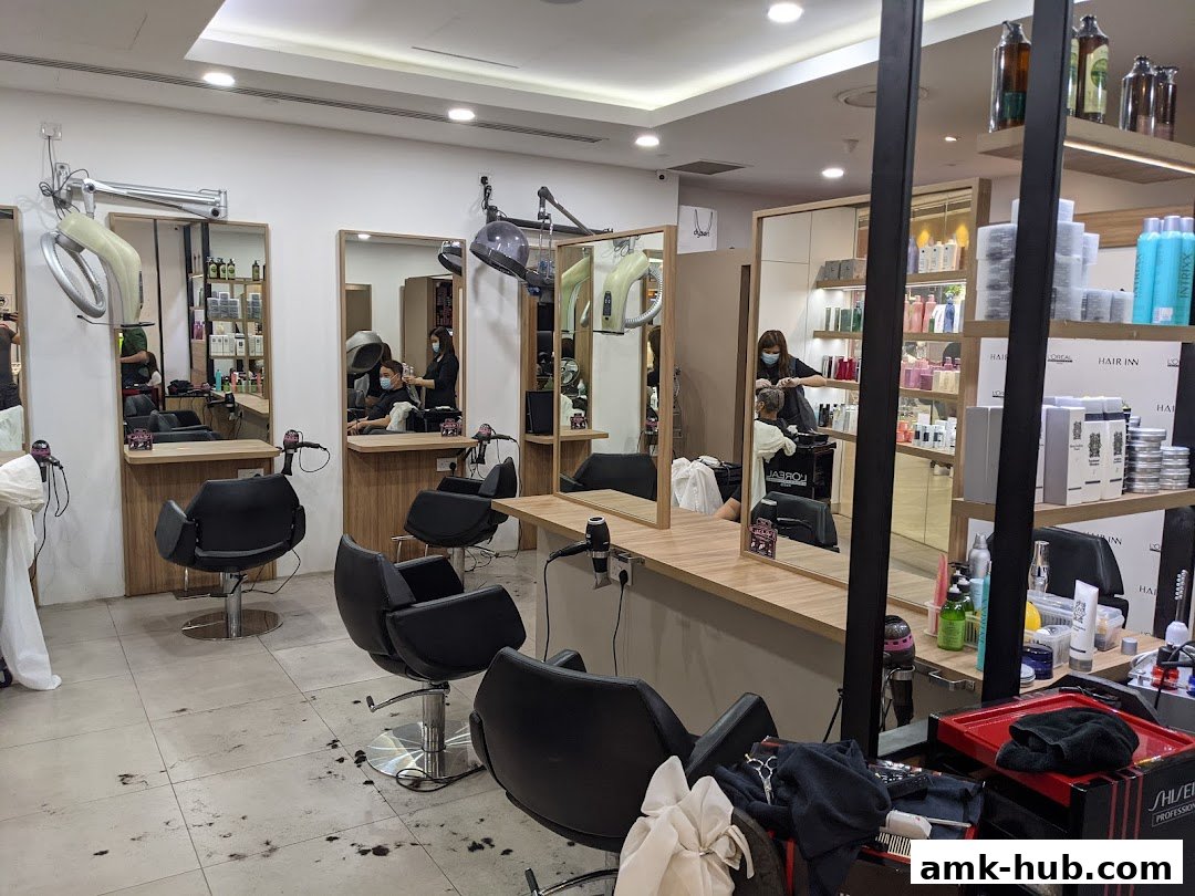 Interior of a modern hair salon with styling chairs, mirrors, and shelves stocked with hair products.