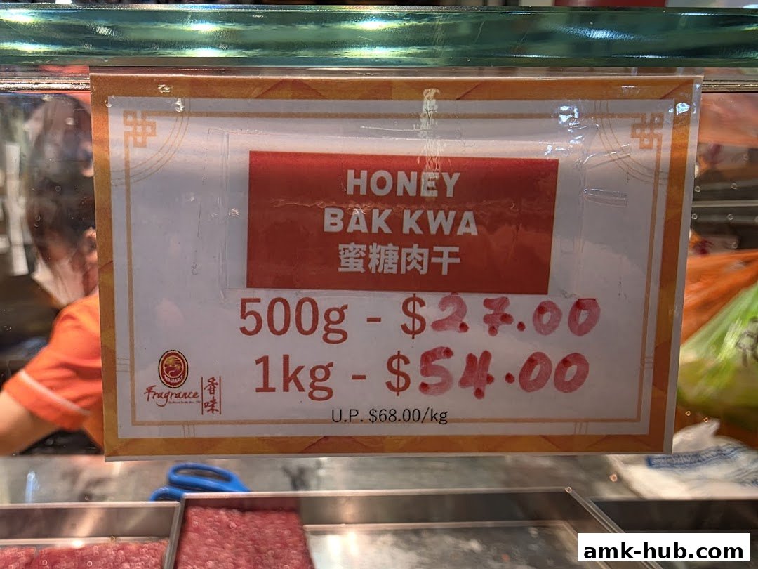 A sign displays prices for Honey Bak Kwa in 500g and 1kg portions.