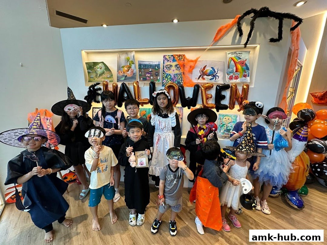 Children dressed in Halloween costumes pose for a photo in a decorated studio.