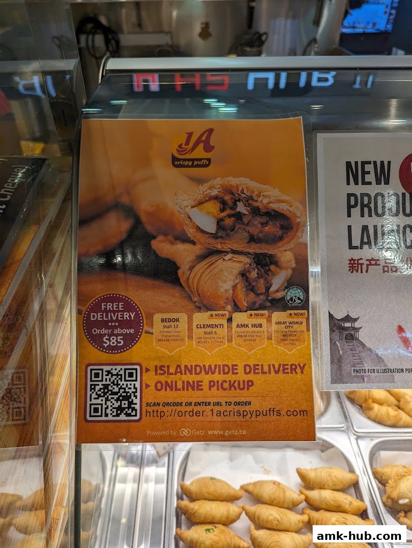 A flyer for 1A Crispy Puffs advertises free delivery and islandwide delivery with a QR code.