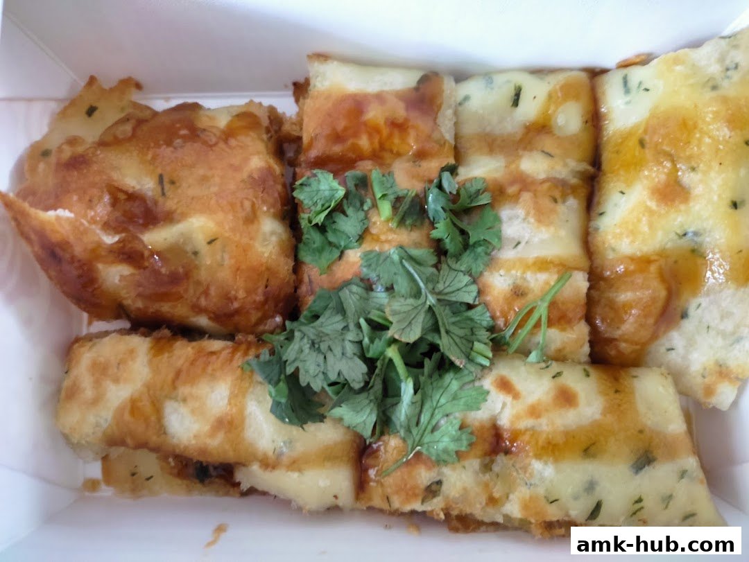 A close-up of Taiwanese street food, featuring crispy fried items and savory pancakes with fresh cilantro.