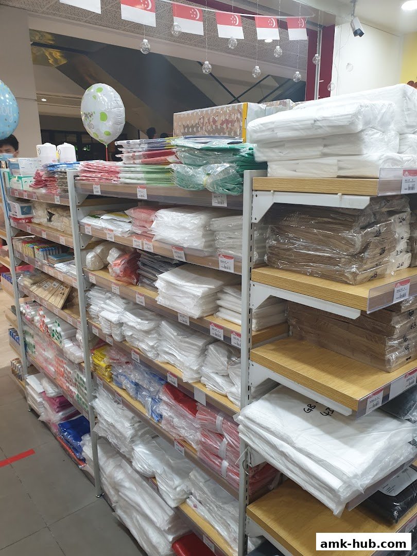 Shelves stocked with various plastic bags and packaging supplies, with Singapore flags overhead.