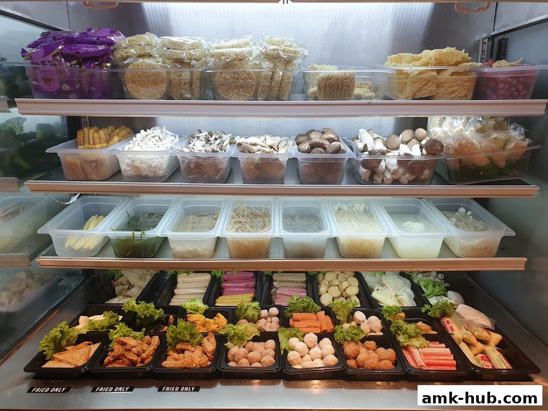 A display of fresh ingredients for Mala Tang, including noodles, vegetables, mushrooms, and meats.
