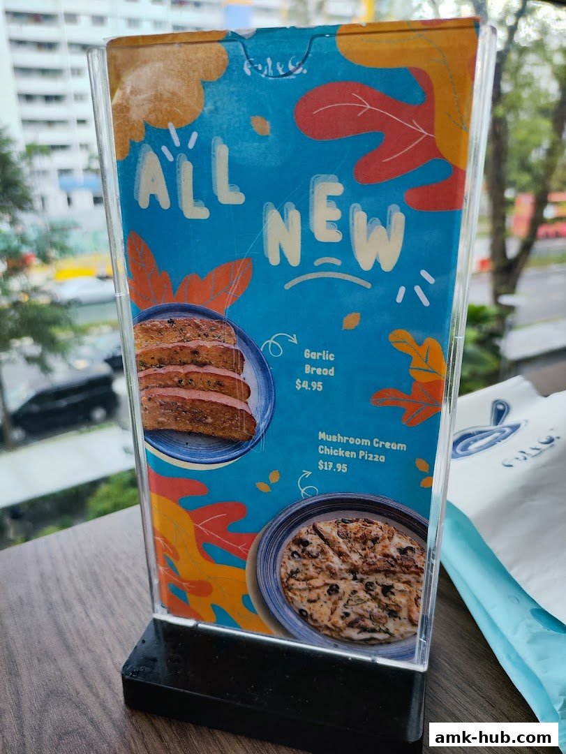 A menu display featuring 'All New' items like Garlic Bread and Mushroom Cream Chicken Pizza.