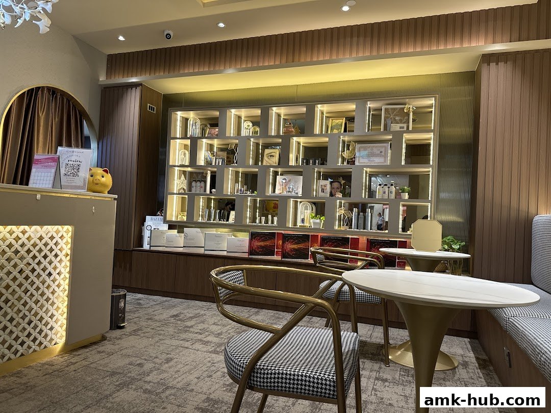Interior of a beauty salon with a reception desk, shelves displaying products, and seating areas.
