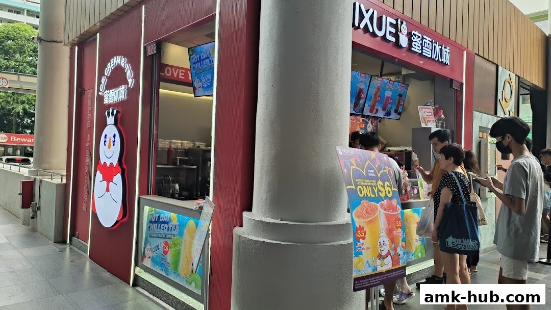 A MIXUE ice cream and tea shop with customers queuing outside.