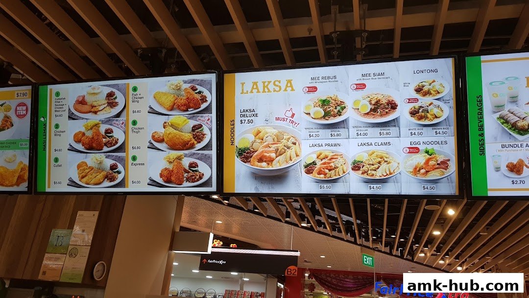 A digital menu board displaying various noodle dishes and nasi lemak meals with prices.