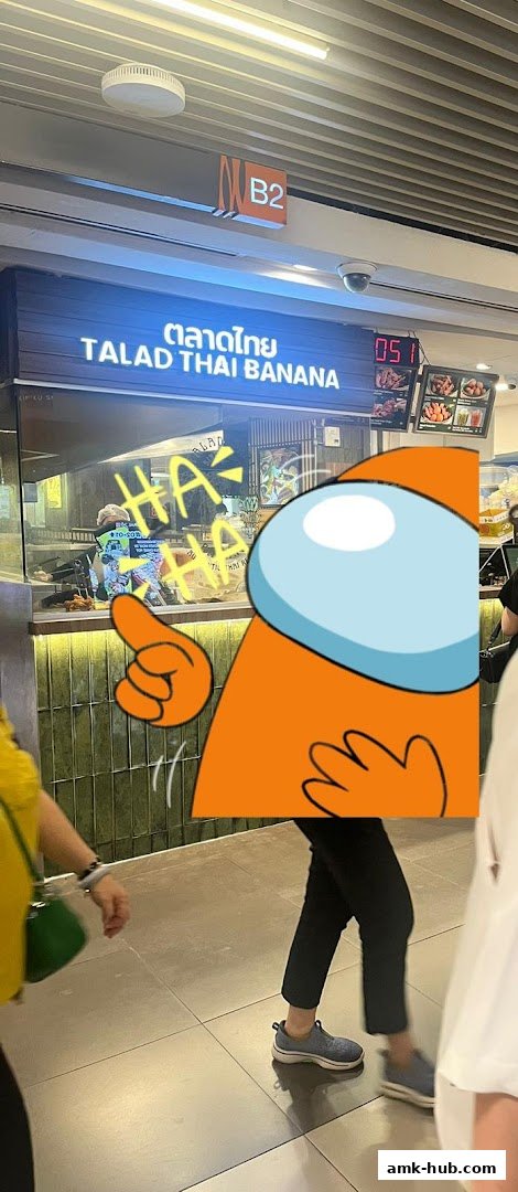 The exterior of Talad Thai Banana shop with a bright sign and food displays.