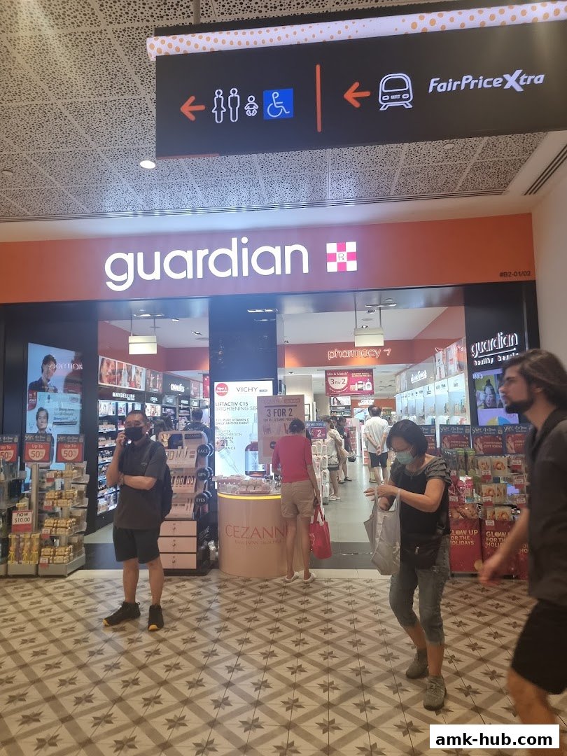 The entrance of a Guardian Health & Beauty Pharmacy with customers inside.