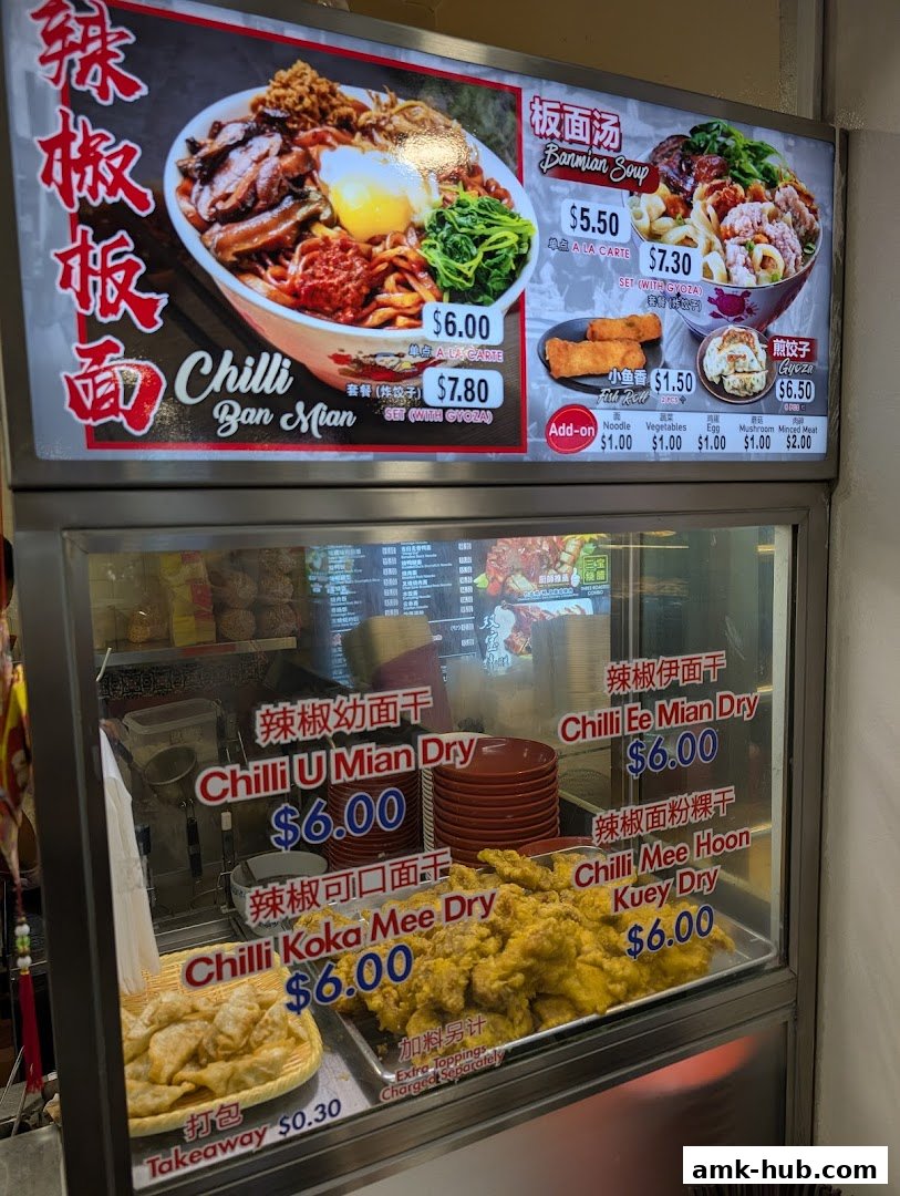 A food stall menu displaying various noodle dishes and add-ons with prices.