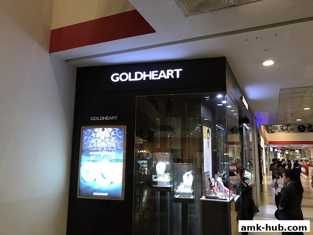 The Goldheart Jewelry store front with illuminated signage and display cases.