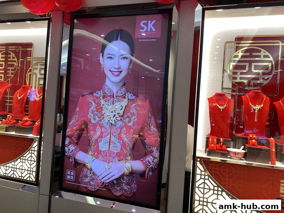 SK Jewellery shop window displaying a model in traditional attire and exquisite gold jewelry.