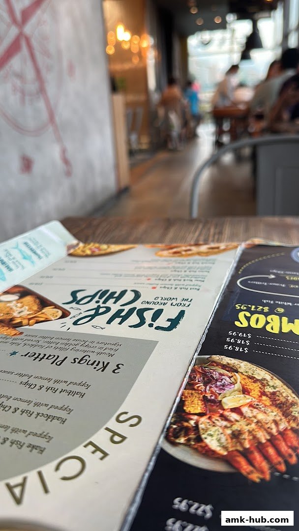 A close-up view of a menu from Fish Co. featuring seafood dishes and prices.
