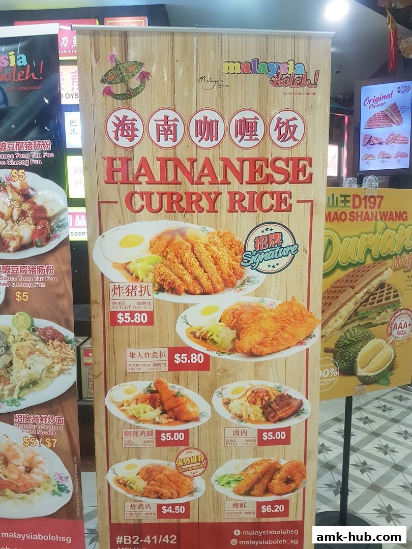 A promotional banner for Malaysia Boleh! featuring Hainanese Curry Rice dishes.