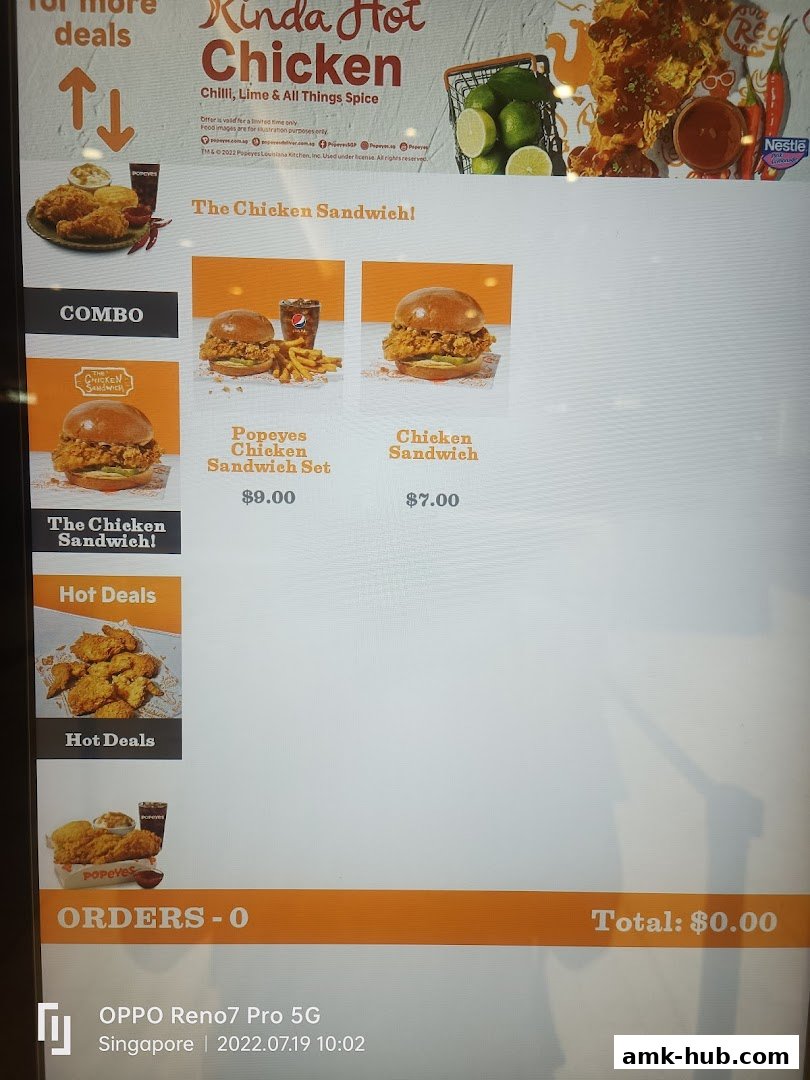 A digital menu board displaying Popeyes' Kinda Hot Chicken and Chicken Sandwich offerings.