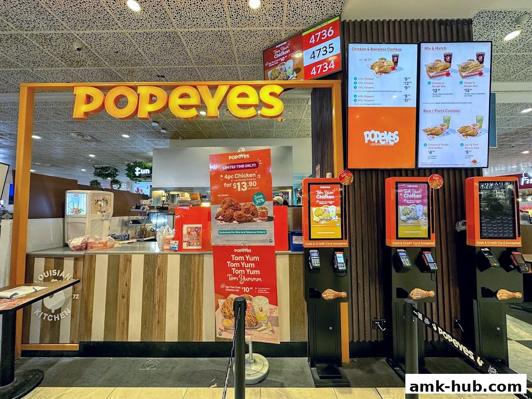 The Popeyes restaurant counter with digital menus and self-order kiosks.