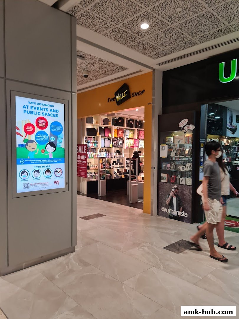 The entrance to The Wallet Shop, displaying various bags and accessories, with a sale sign.