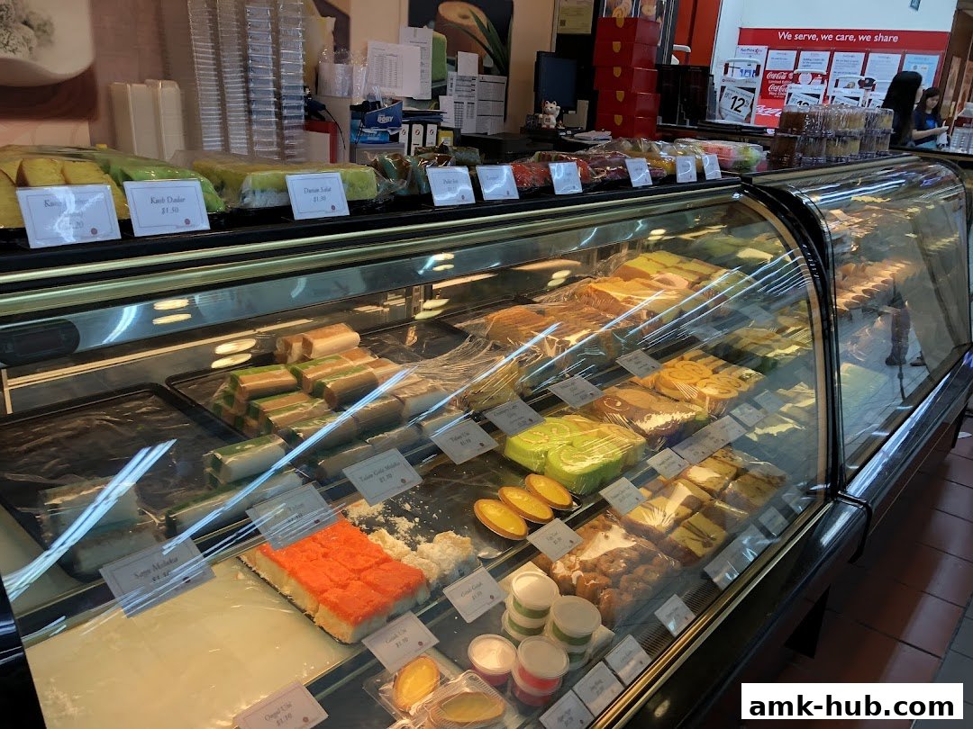 A display case filled with various colorful cakes and pastries at Bengawan Solo.