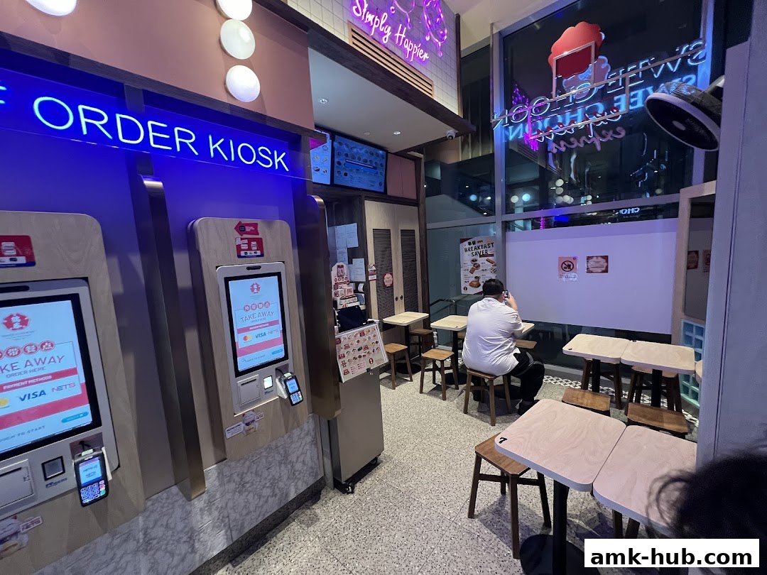 Interior view of a Swee Choon Tim Sum Restaurant Express with order kiosks and seating.