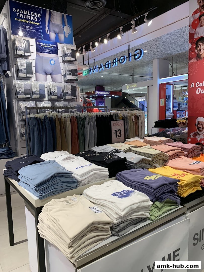A display of folded t-shirts and underwear in a Giordano store.