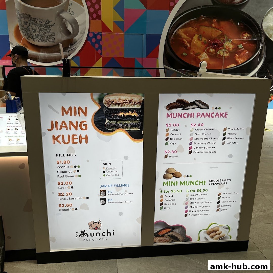 A brightly lit menu board for Munchi Pancakes, showcasing various pancake fillings and flavors.