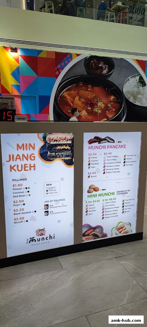 A menu display for Munchi Pancakes, showcasing Min Jiang Kueh and various pancake fillings and flavors.