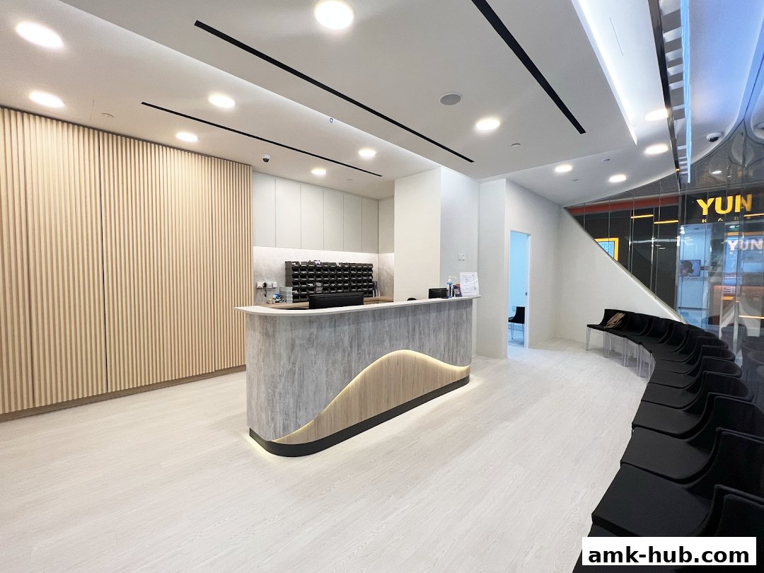 Interior of a modern clinic waiting area with a reception desk and seating.