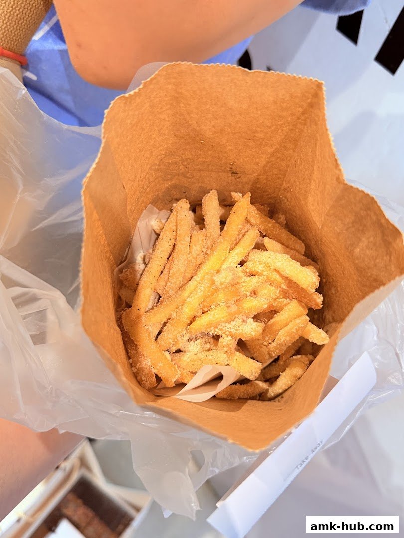 A paper bag filled with delicious, seasoned french fries.