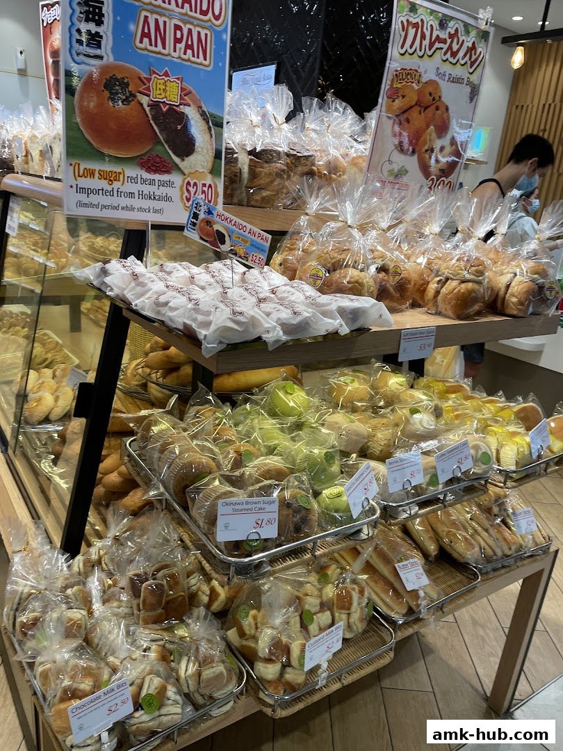 A display of freshly baked breads and pastries at a bakery.